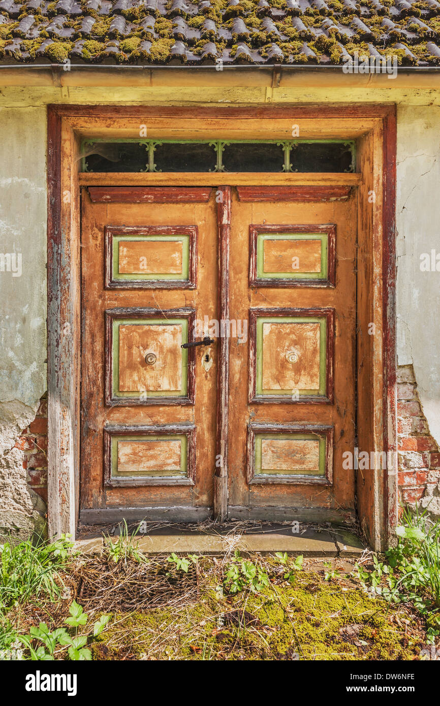 Old door in a dilapidated apartment building. Stock Photo