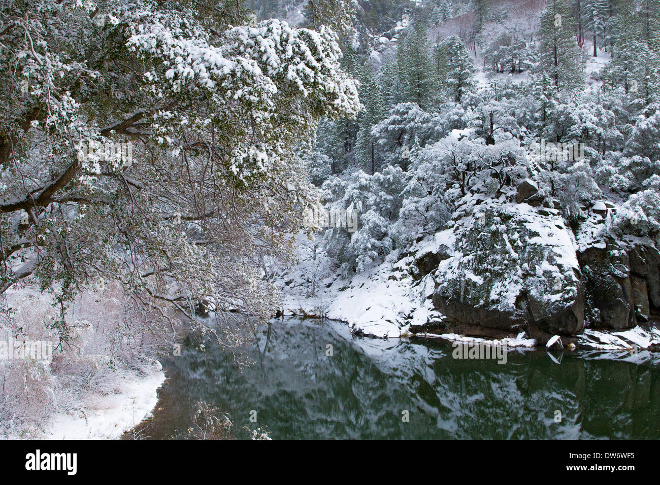 A dusting of snow covers the banks of the North Fork of the Feather River Stock Photo