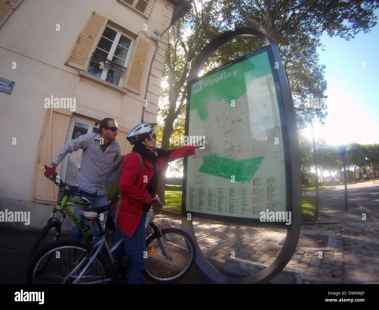 Cycling couple checking the map at Viroflay, just outside Versailles, Paris, France. No MR or PR Stock Photo