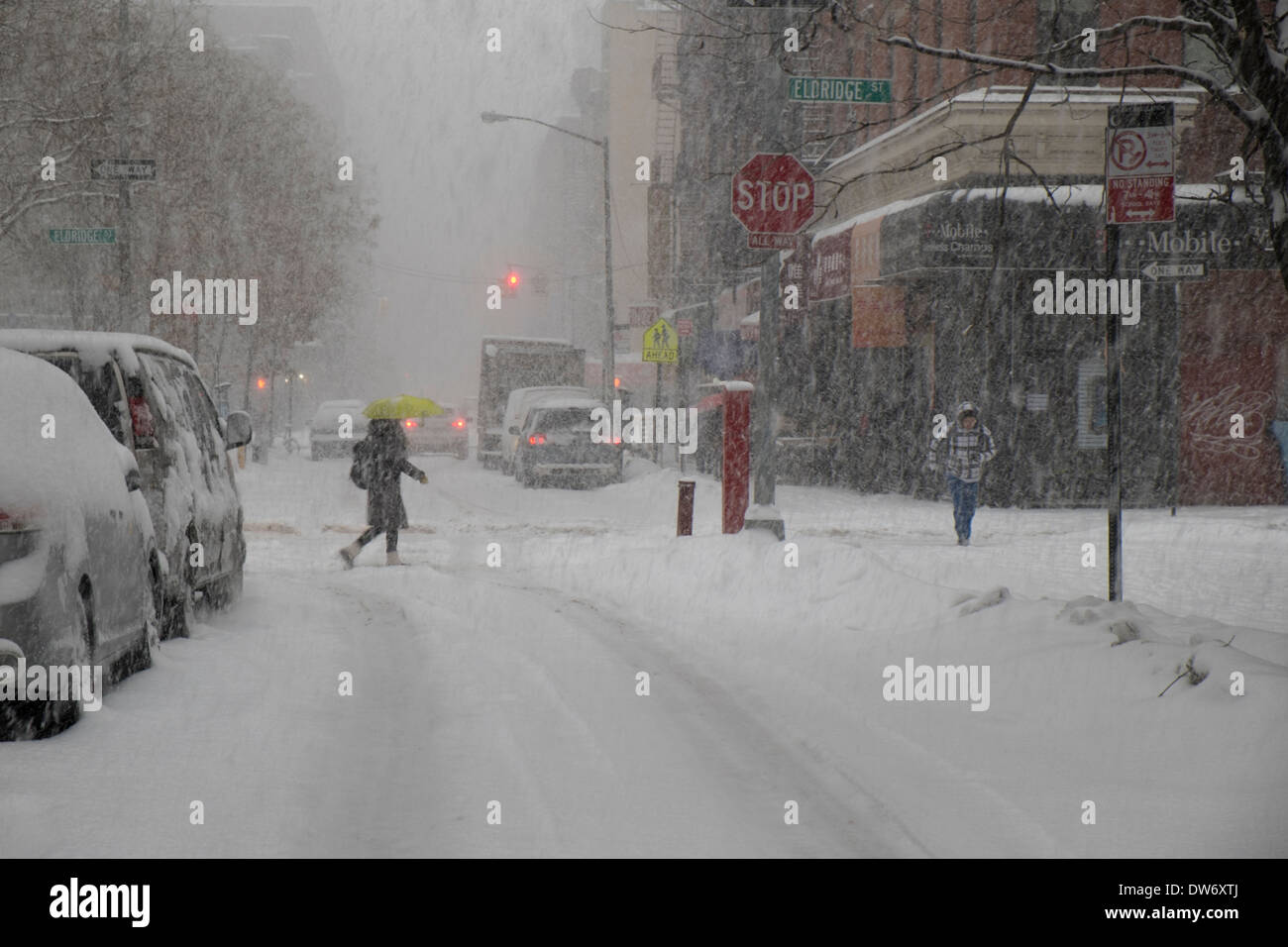 Pedestrians Crossing Hester Street In Chinatown New York City During Heavy Snowstorm Stock Photo 