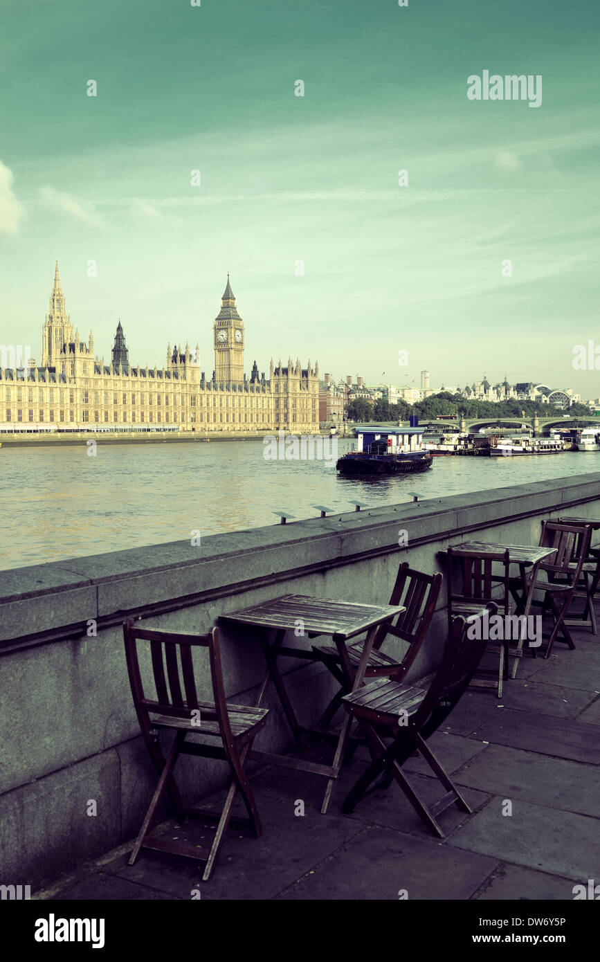 Chairs at waterfront of Thames River with Big Ben and House of Parliament in London. Stock Photo