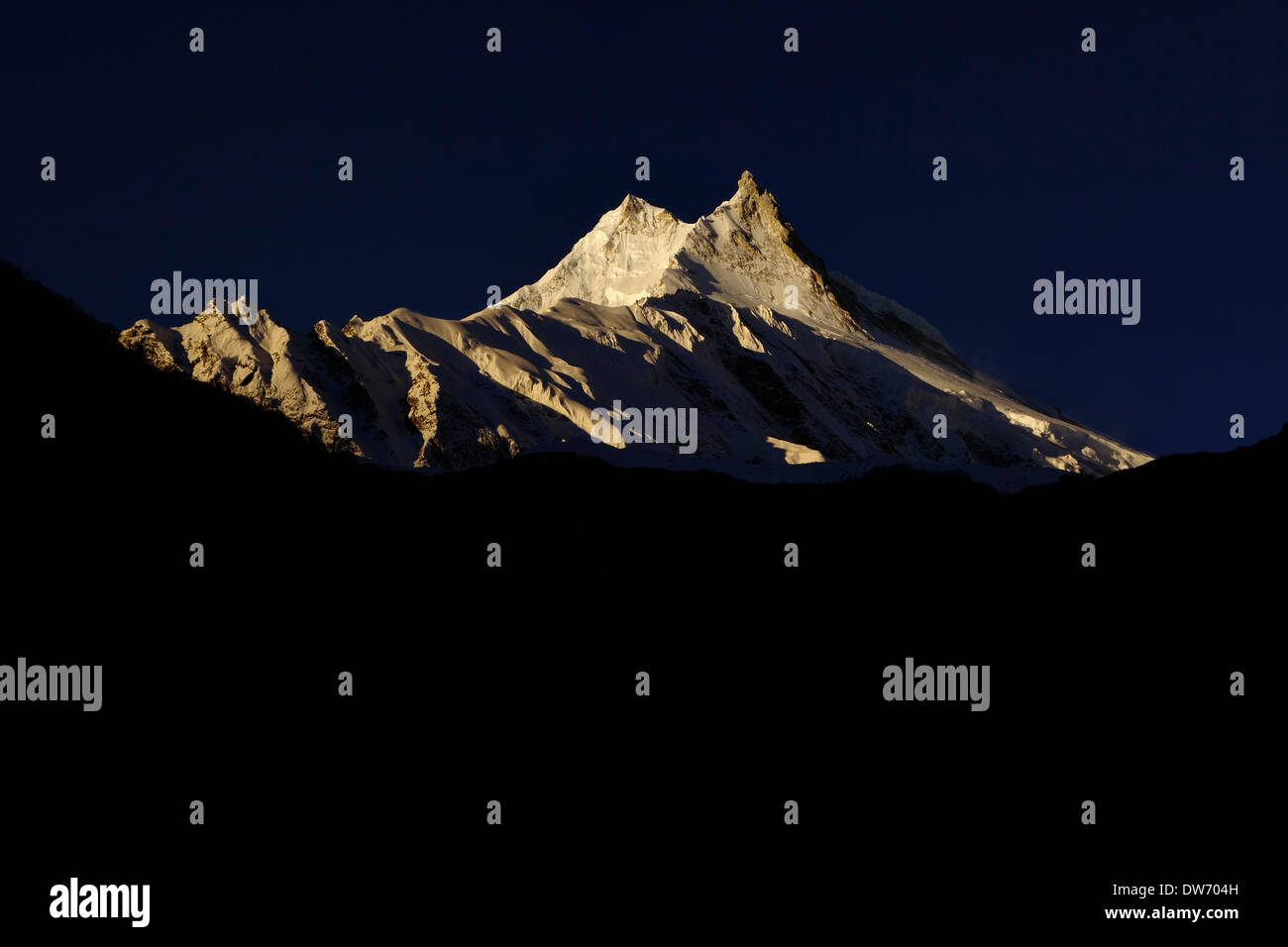 Manaslu at sunrise. At 8156 meters (26,759 feet) Manaslu is the eighth highest peak on the planet. Stock Photo