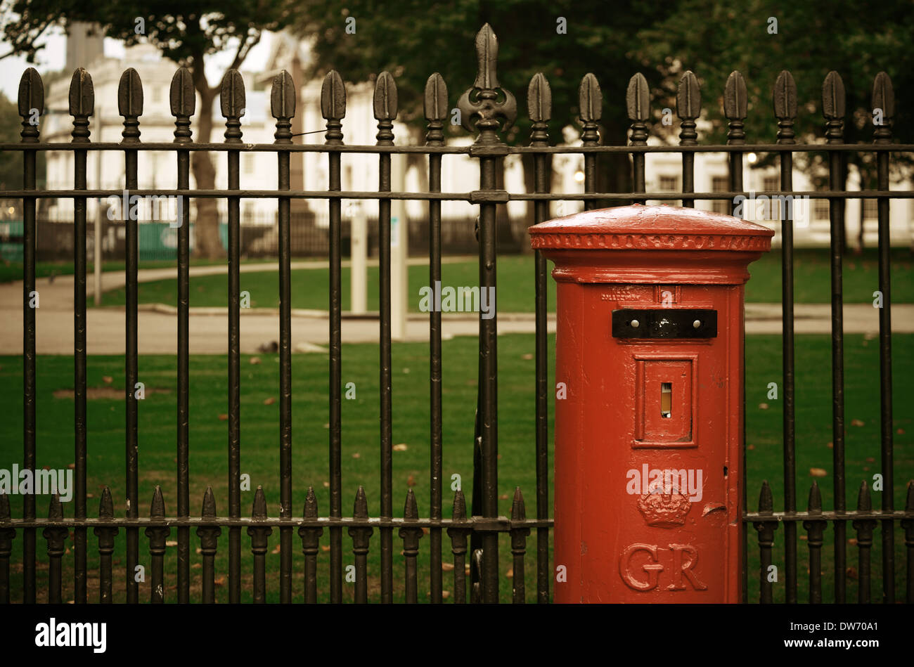 Red post box in street with historical architecture in London. Stock Photo