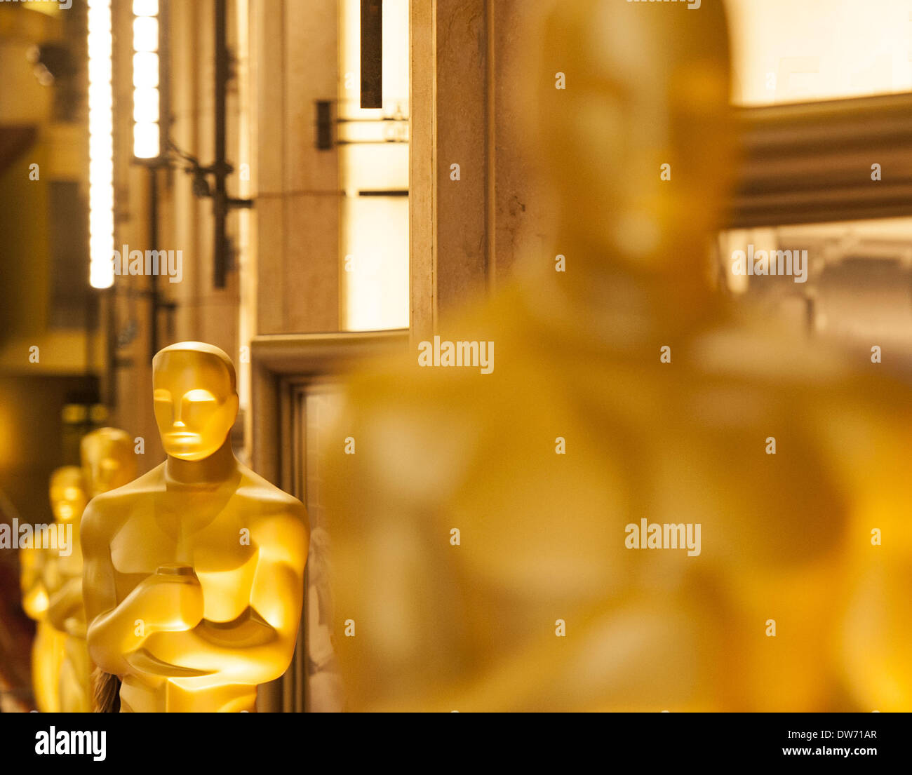 March 1, 2014 - Hollywood/Los Angeles, California, USA - A line of gold Oscars could be seen set up along the main entrance hall of the Dolby Theatre in Hollywood. Preparations for the Oscars scheduled for Sunday March 2, 2014, continued on Saturday in anticipation of what could be a wet and stormy Oscar event. Work continued on the red carpet arrival area after two days of stormy weather left soggy displays, carpet and bleachers despite large tents assembled with thick clear plastic in order to keep celebrities, nominees, presenters and guests dry on Sunday. Media representatives includin Stock Photo