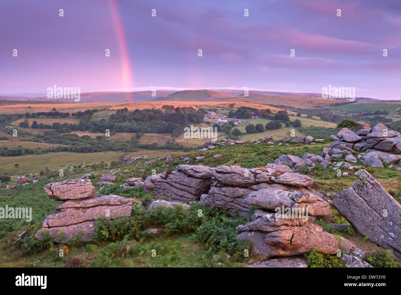 Rainbow over Dartmoor at dawn, Holwell Tor, Dartmoor, Devon, England. Summer (August) 2013. Stock Photo