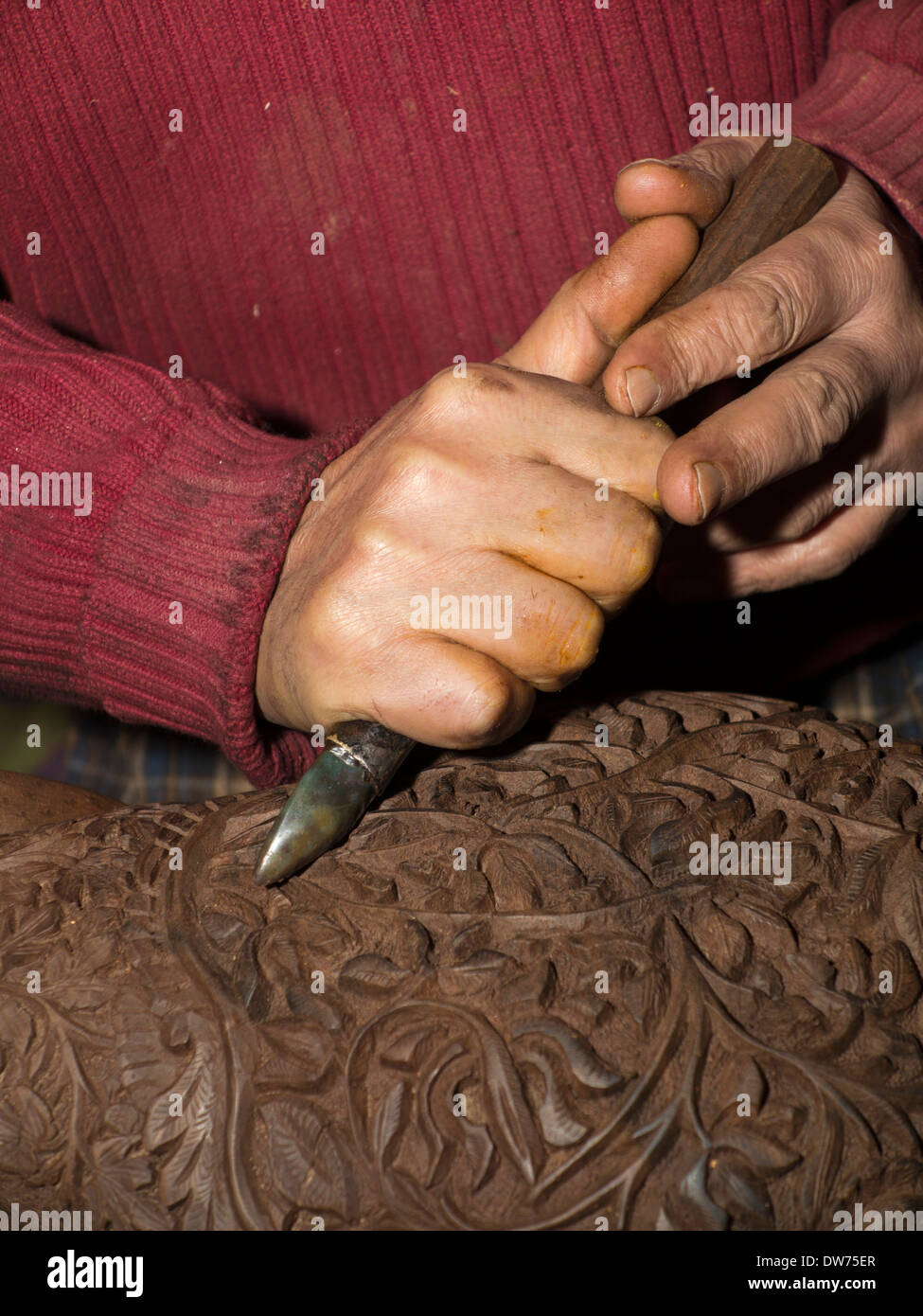 India, Kashmir, Srinagar, Crafts, man burnishing carved wooden bowl with agate stone Stock Photo