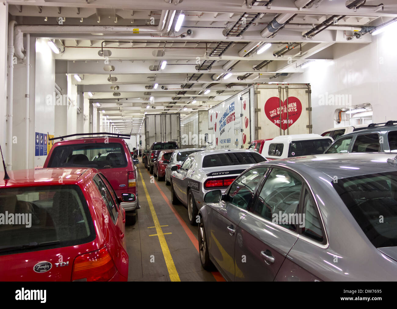 Cars, trucks and other vehicles on a vehicle deck of a BC ferry, traveling between Vancouver Island and the Mainland. Stock Photo