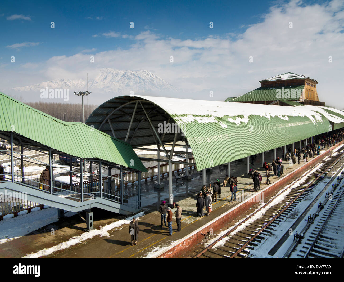 India, Kashmir, Srinagar Railway station in winter, passengers waiting on platform for arrival of train Stock Photo
