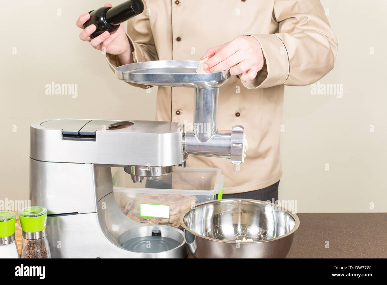 chef makes mincemeat using a food processor Stock Photo