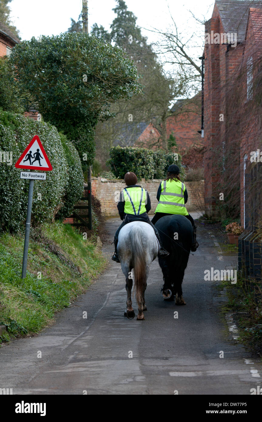 Horse riders in Mill Lane, Feckenham, Worcestershire, England, UK Stock