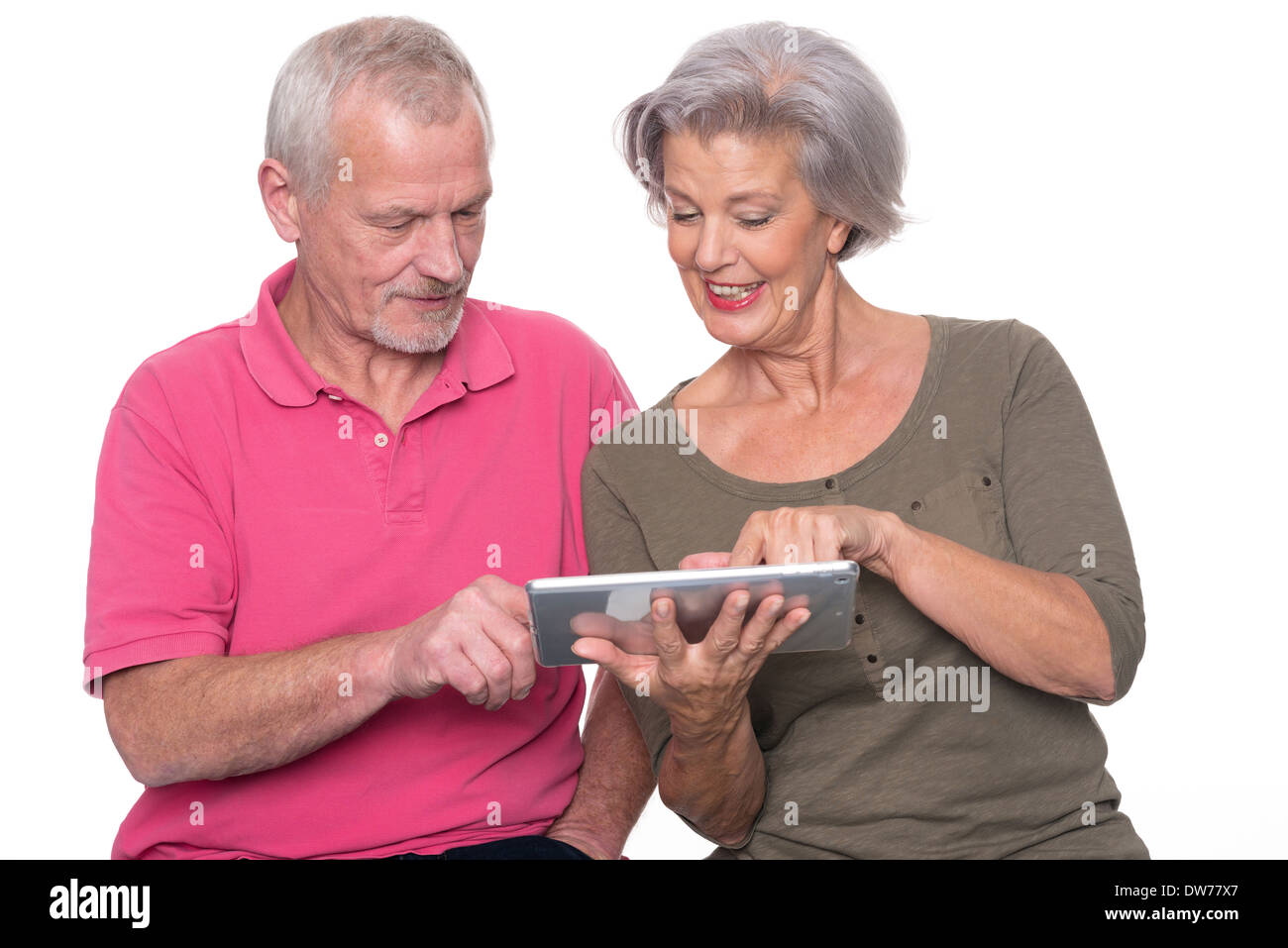 Senior couple with tablet computer in front of white background Stock Photo