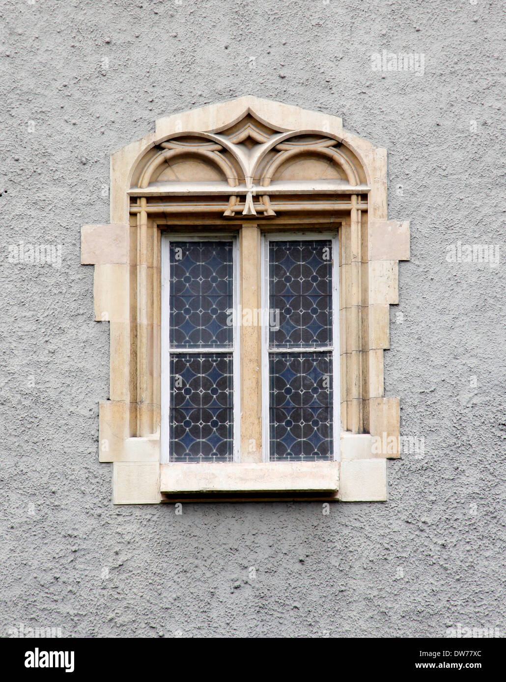 Ornate Gothic castle window in the wall. Stock Photo