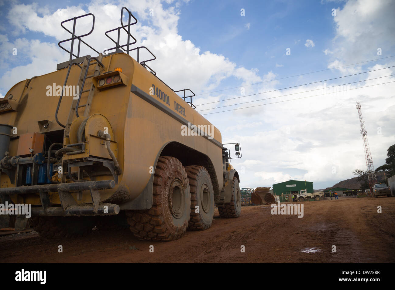 A volvo articulated diesel truck carrying 34,000L of Diesel prepares to refuel in a large open cast copper/  gold mine in Zambia Stock Photo