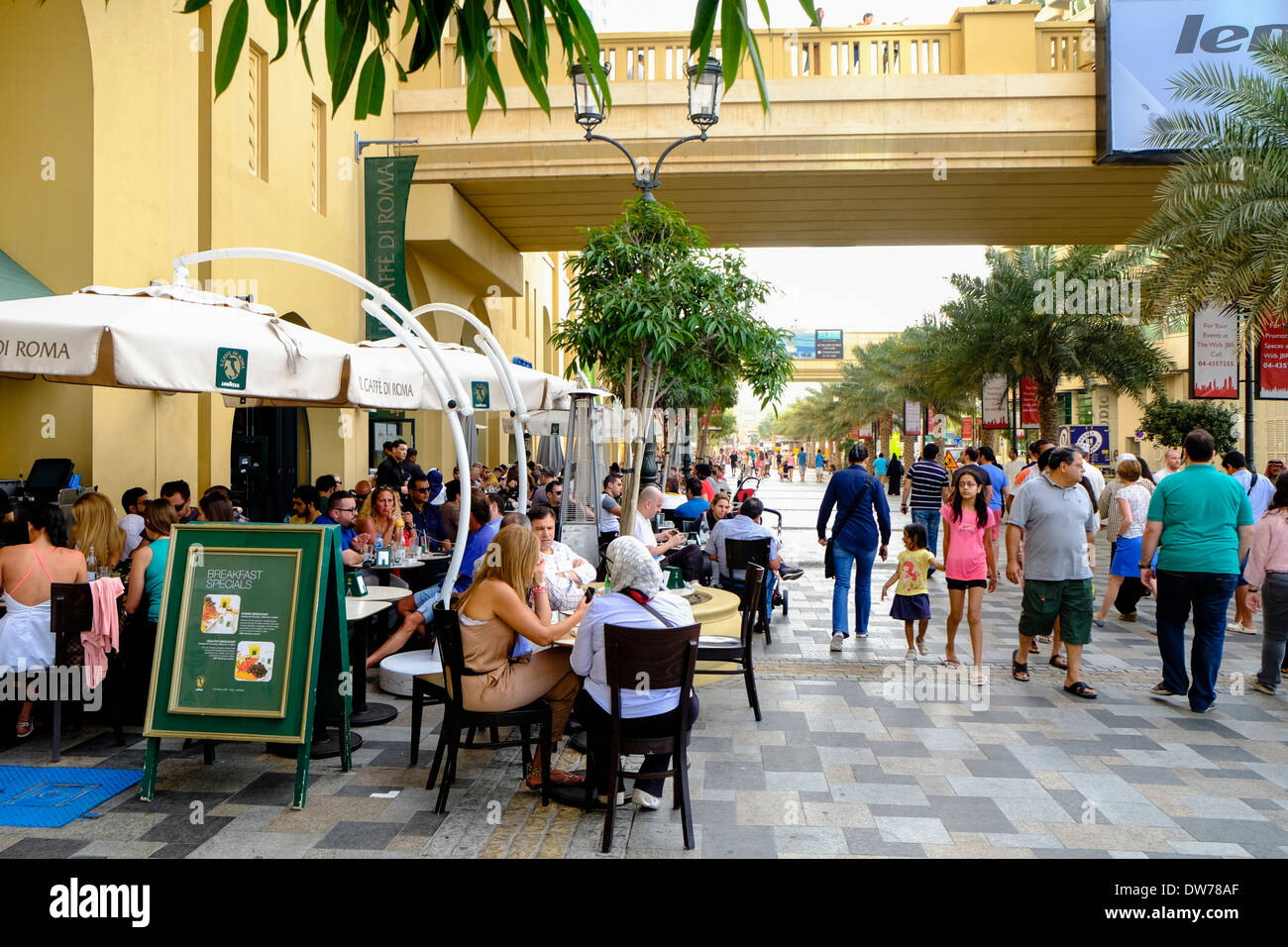 Busy cafes on The Walk shopping and dining street at Jumeirah Beach Residences (JBR) in Dubai United Arab Emirates Stock Photo