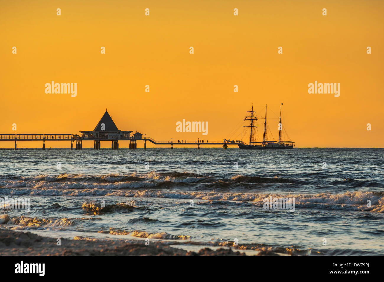 A sailing ship lands at evening at the Heringsdorf Pier, Island of Usedom, Mecklenburg-Western Pomerania, Germany, Europe Stock Photo