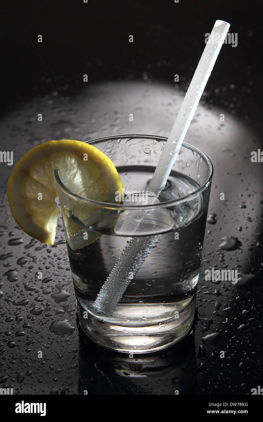 Water or Cocktail on a bar with water drops Stock Photo