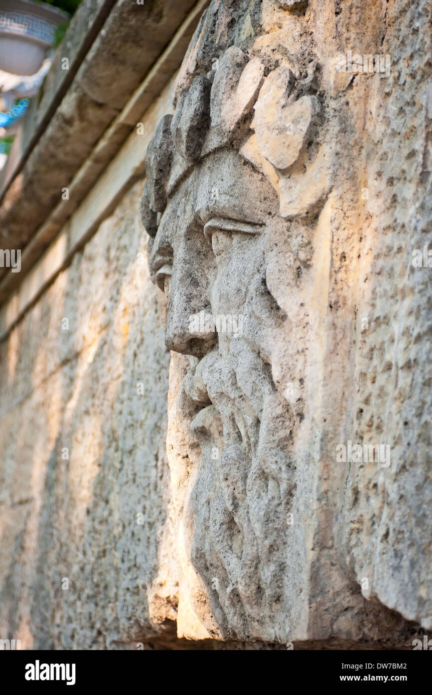 face of a man with a beard carved in stone Stock Photo