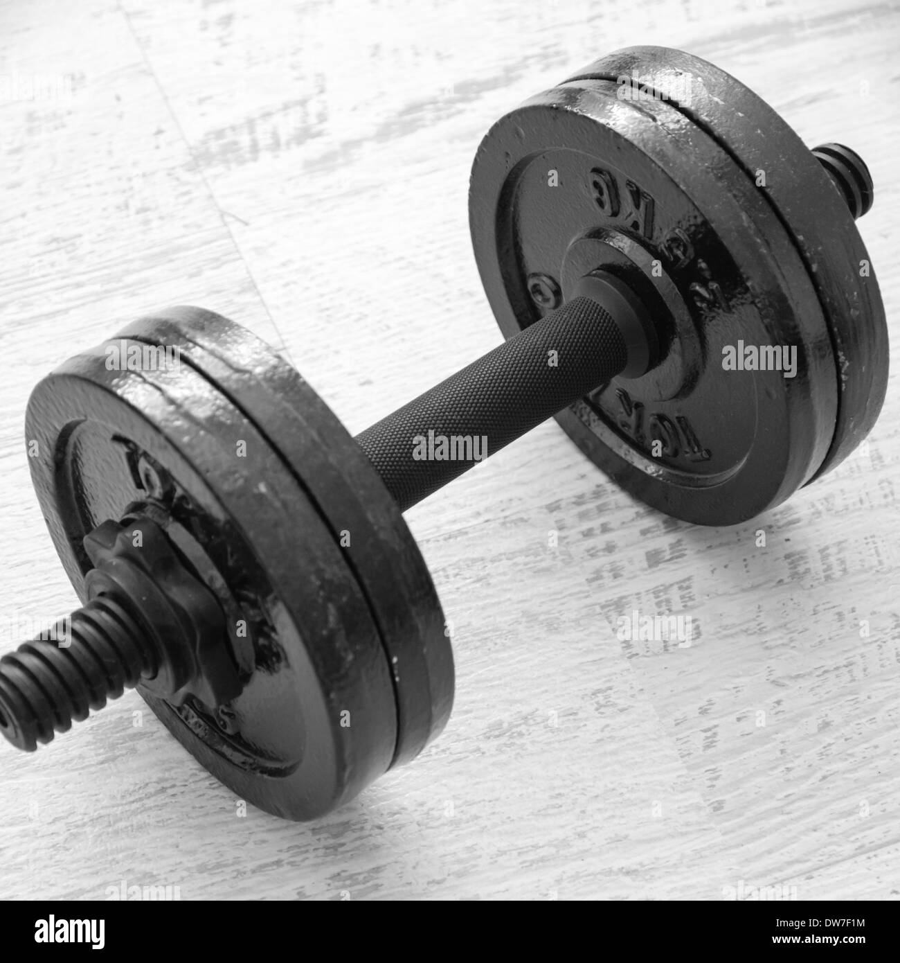 Exercise weights - iron dumbbell on a white wooden floor Stock Photo ...