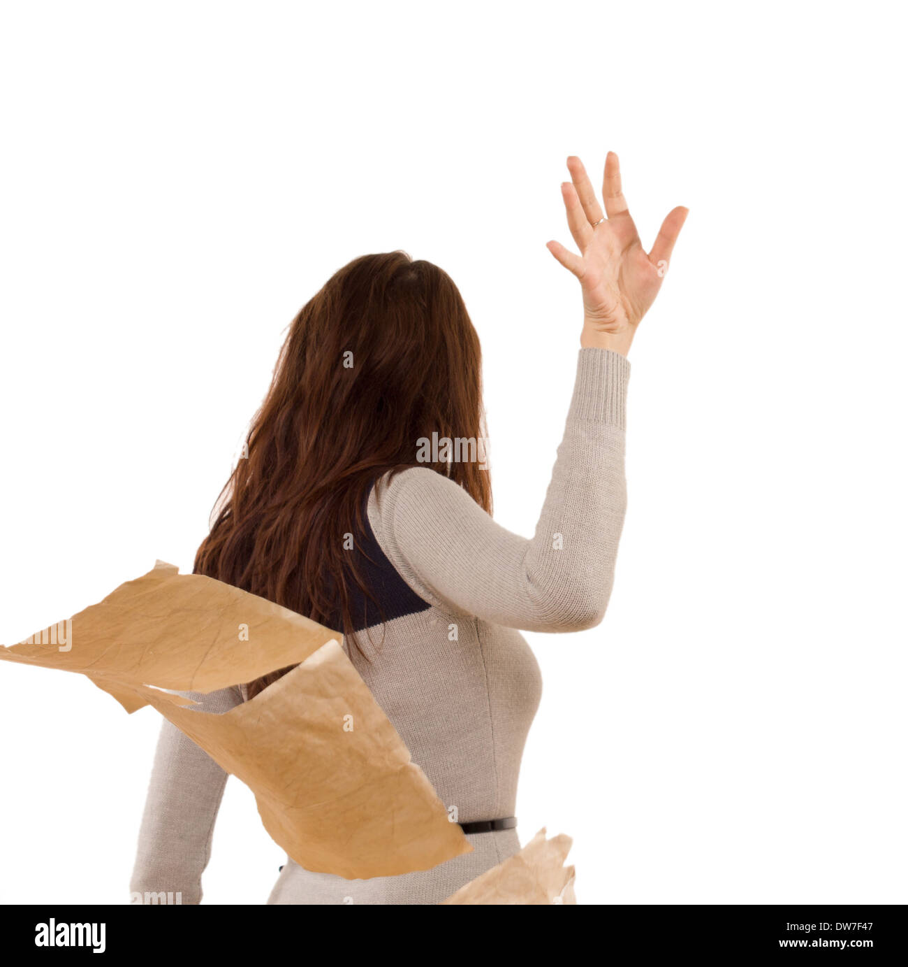 Temperamental woman tossing aside papers in anger as she storms off after a disagreement, isolated on white Stock Photo