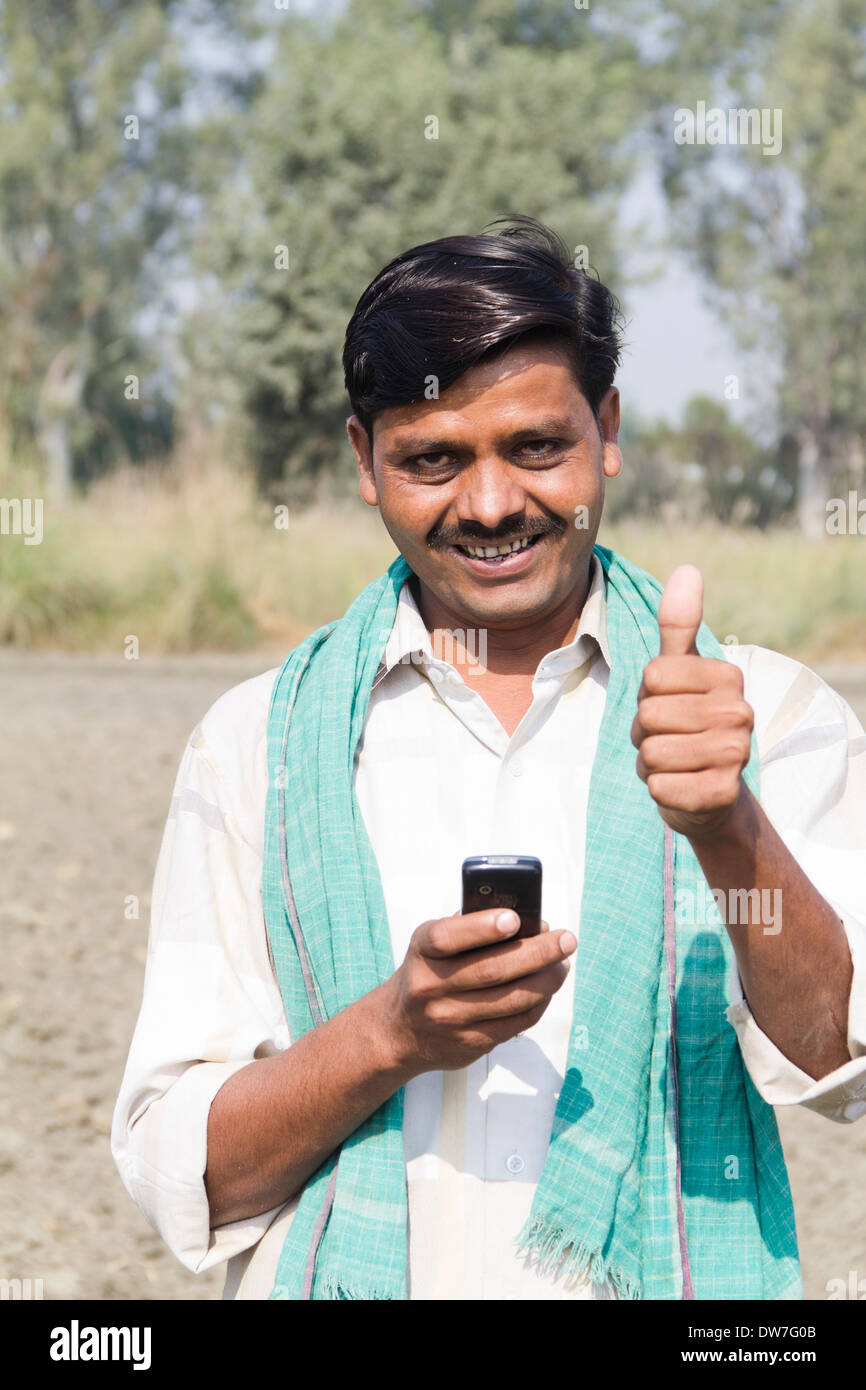 1 indian farmer standing with mobile Stock Photo