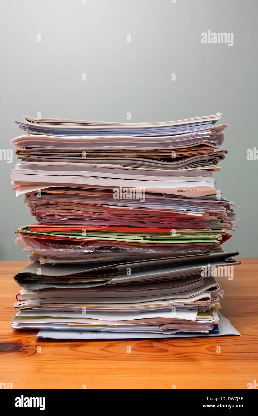 a pile of old office files and paperwork on a desk Stock Photo