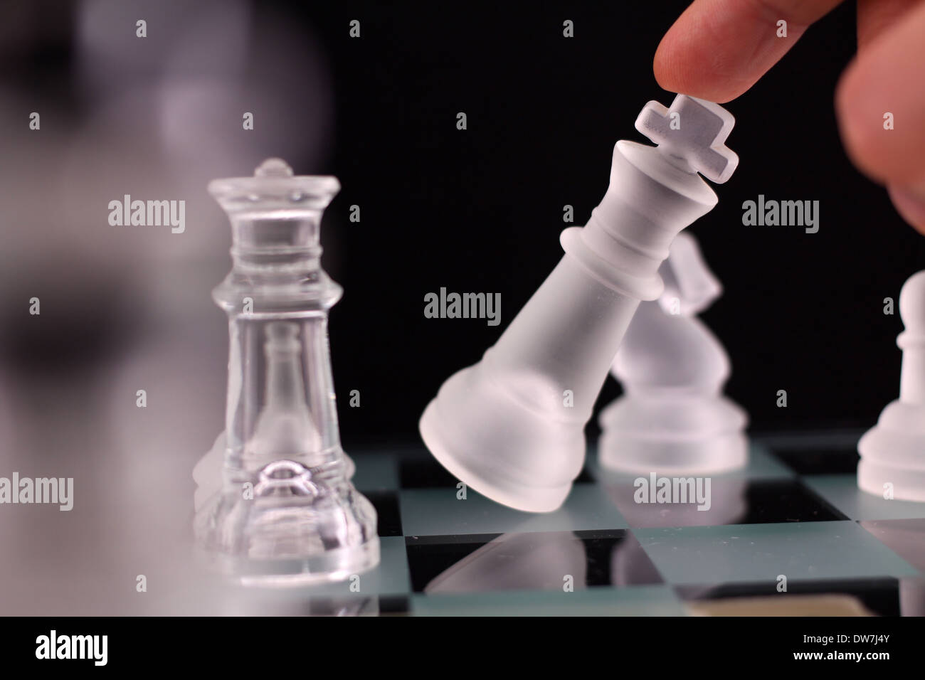 Crystal chess. The end of the game. King goes down. Stock Photo