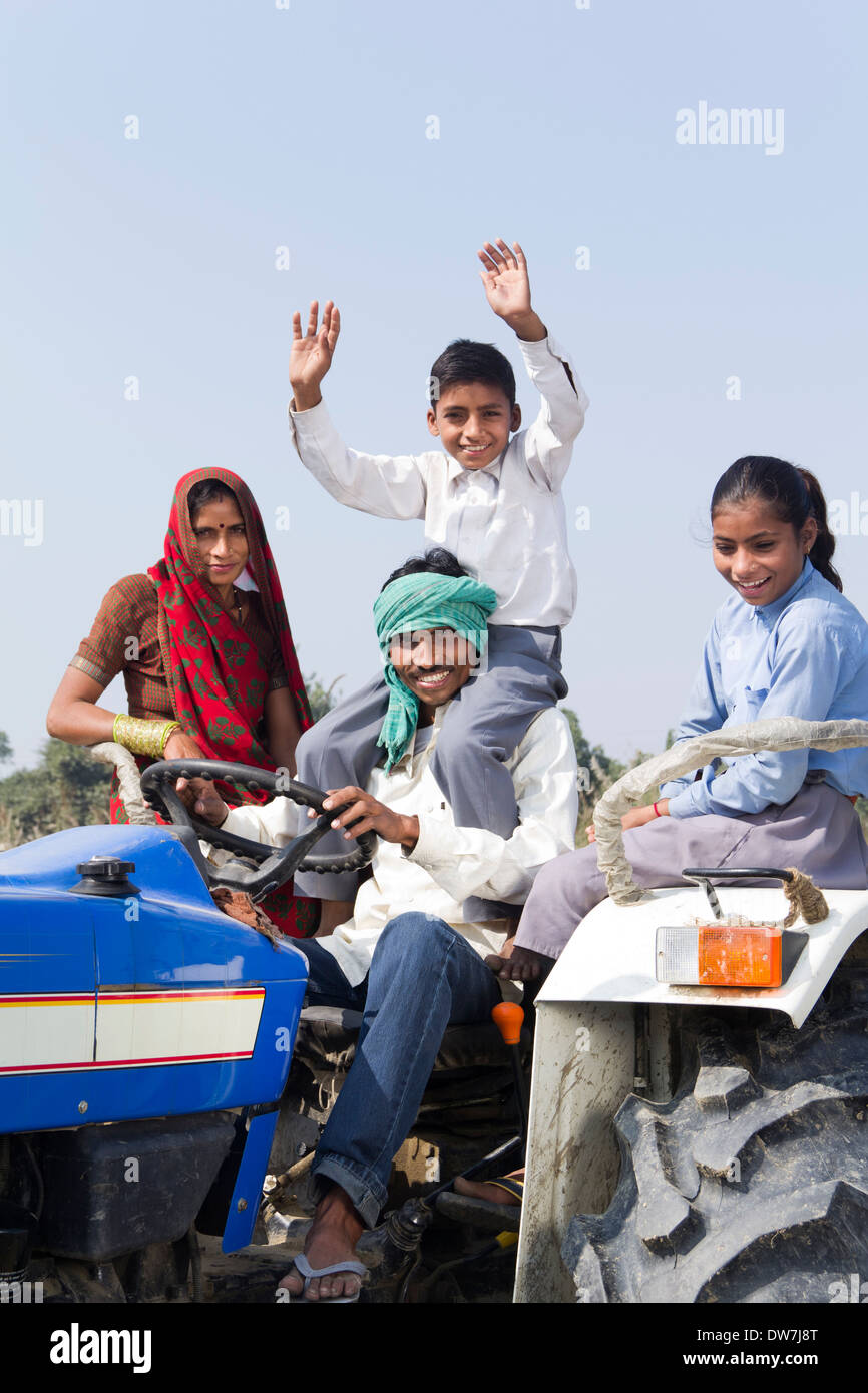 Indian farmer driving tractor with his family Stock Photo - Alamy