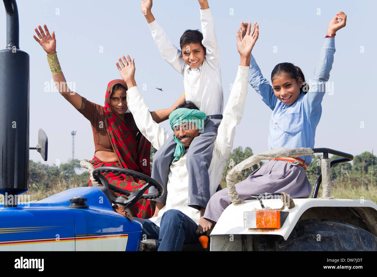 Indian farmer driving tractor with his family Stock Photo - Alamy