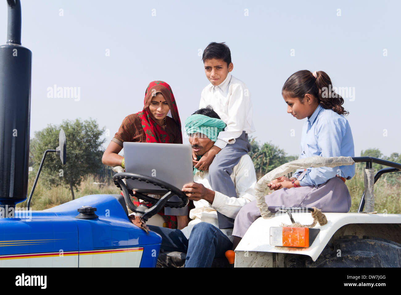 Indian farmer driving tractor with his family Stock Photo - Alamy