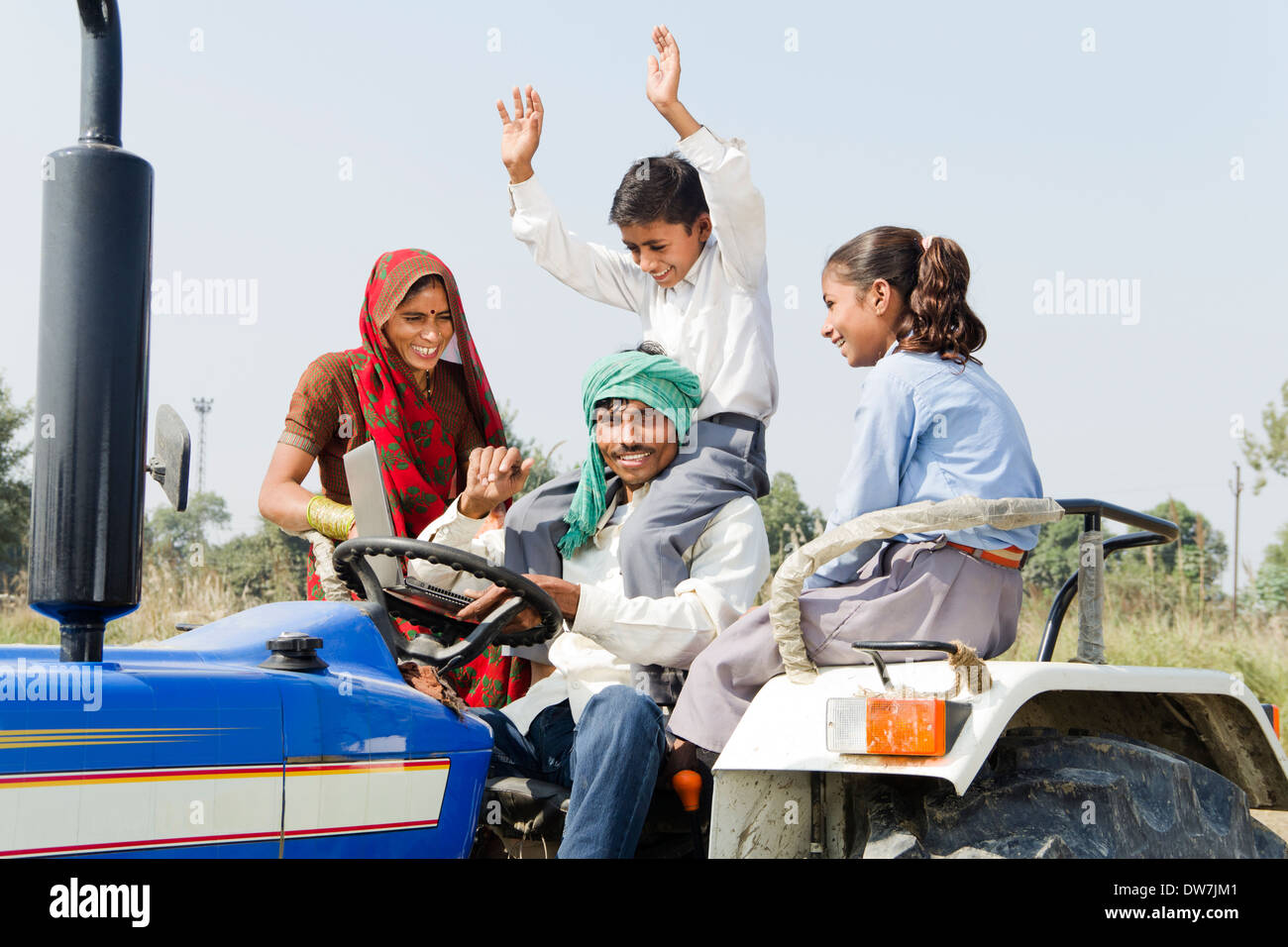 Indian farmer driving tractor with his family Stock Photo - Alamy