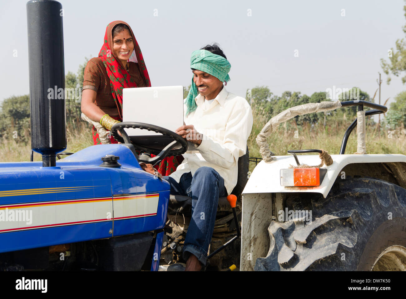 Indian farmer driving tractor Stock Photo Alamy