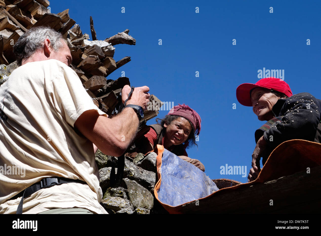 Trekker taking a picture of women in Nepal's Tsum Valley. Stock Photo