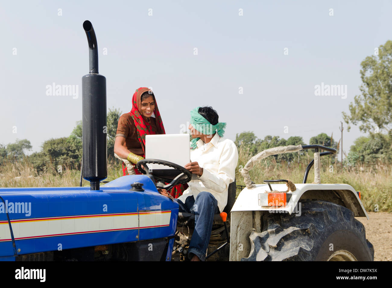 Indian farmer driving tractor Stock Photo Alamy