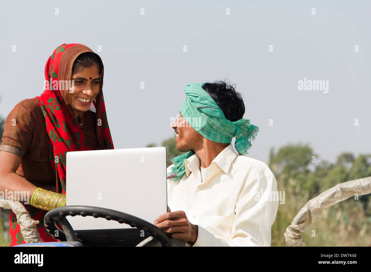 Indian farmer driving tractor Stock Photo - Alamy