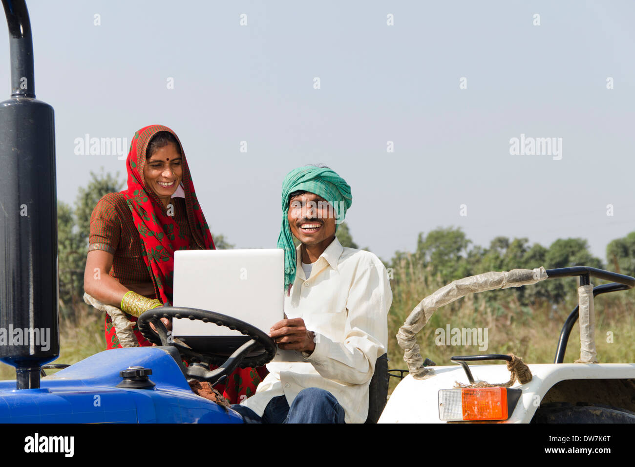Indian farmer driving tractor Stock Photo - Alamy