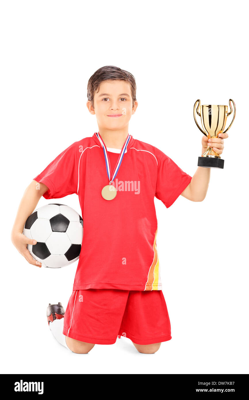 Junior football player holding a ball and golden cup Stock Photo