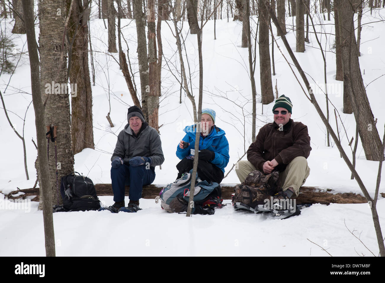 Winter hikers relax and rest along a snow-covered trail on Mount Greylock, Adams, MA. Stock Photo