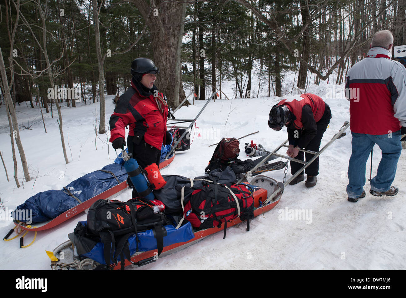 Two members of the Thunderbolt Ski Patrol check their pull sleds after the Annual Thunderbolt Ski Run in Adams MA. Stock Photo