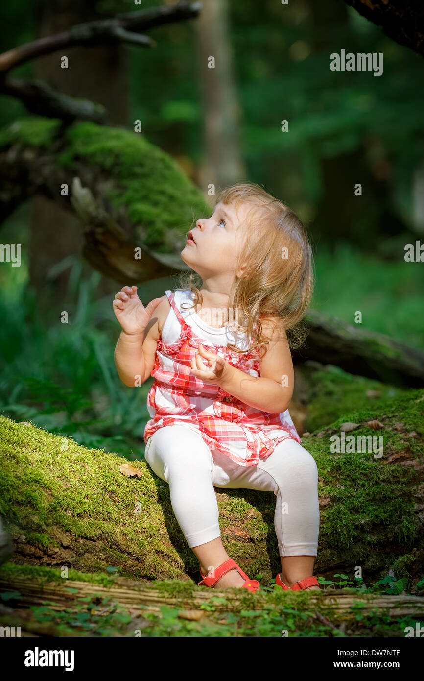 Little girl in the forest Stock Photo - Alamy