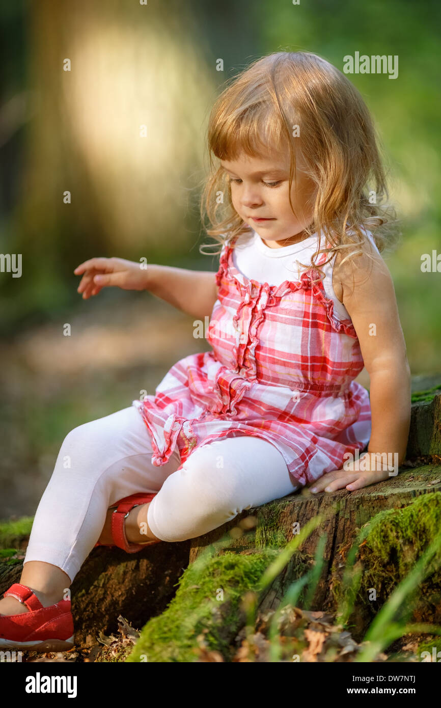 Little girl in the forest Stock Photo - Alamy