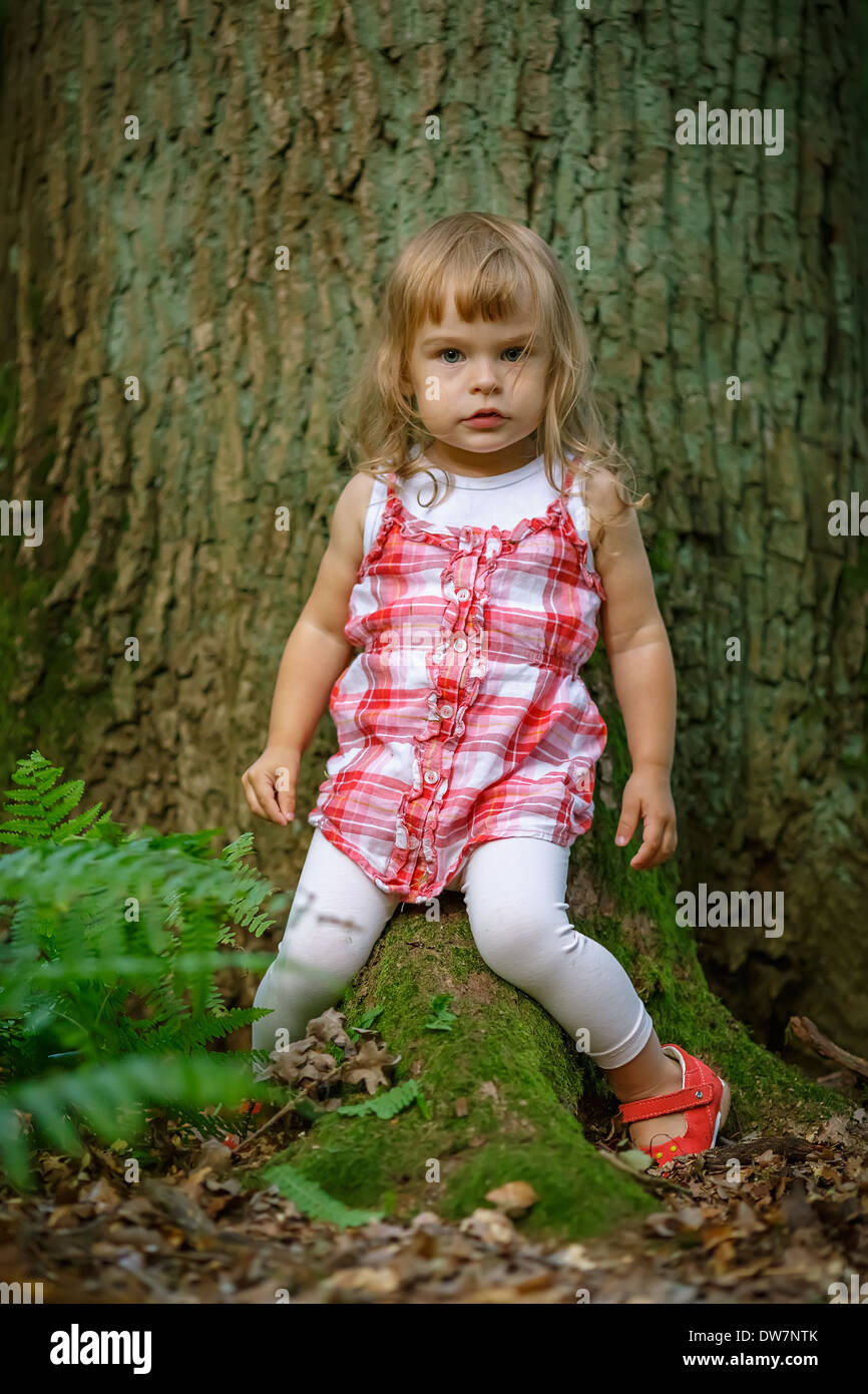 Little girl in the forest Stock Photo - Alamy