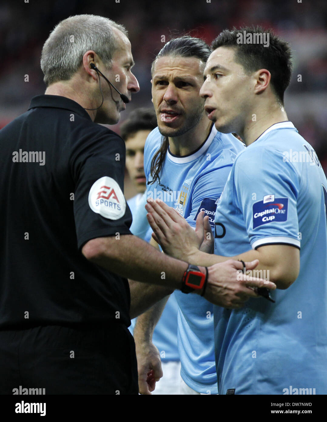 London. 2nd Mar, 2014. Samir Nasri(R) and Martin Demichelis (C) of Manchester City argues with referee Martin Atkinso during the Capital One Cup(The League Cup) Final between Manchester City and Sunderland at Wembley Stadium in London, Britain on March 2, 2014. Manchester City won 3-1. © Wang Lili/Xinhua/Alamy Live News Stock Photo