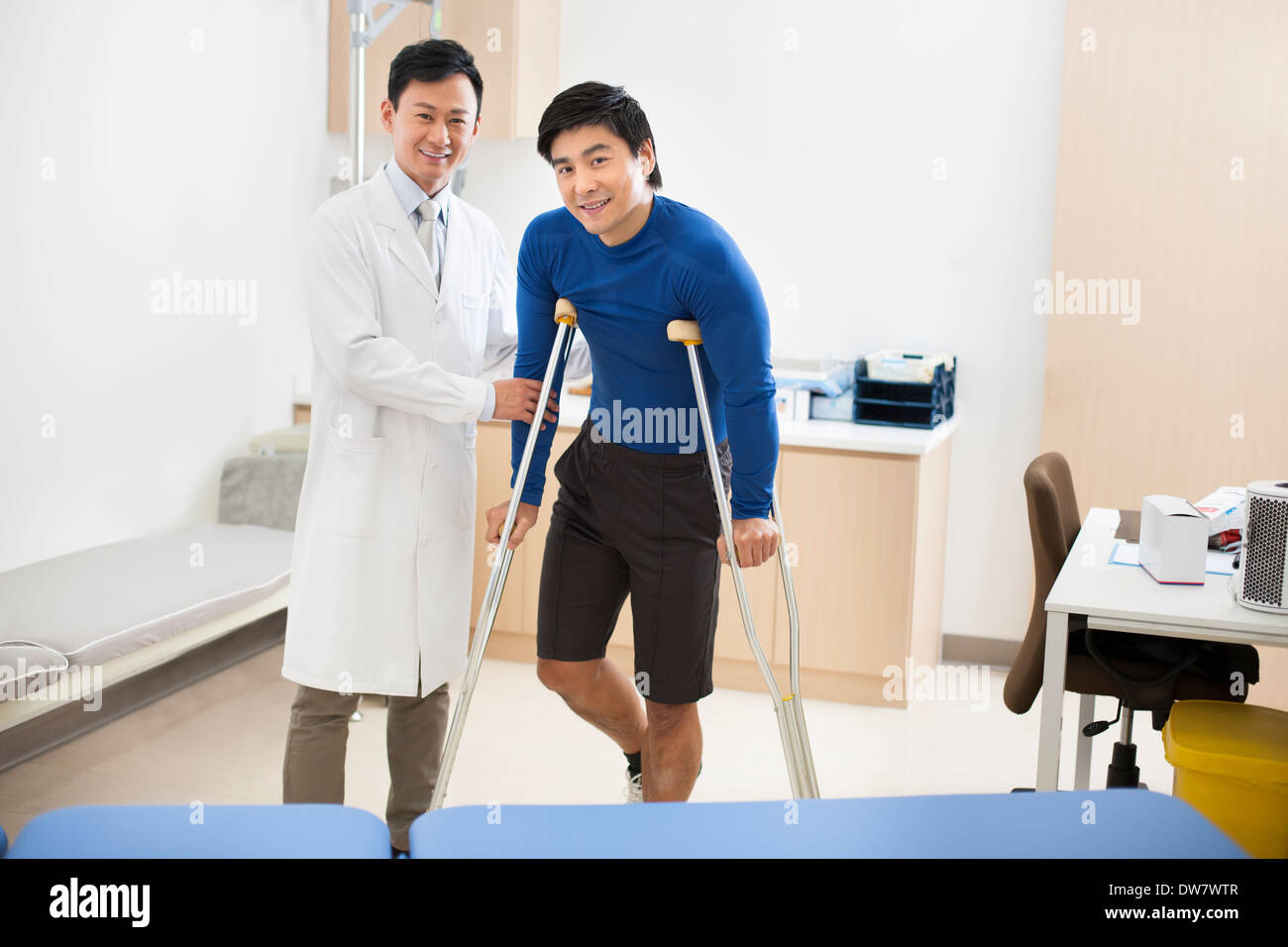 Patient with crutches Stock Photo Alamy