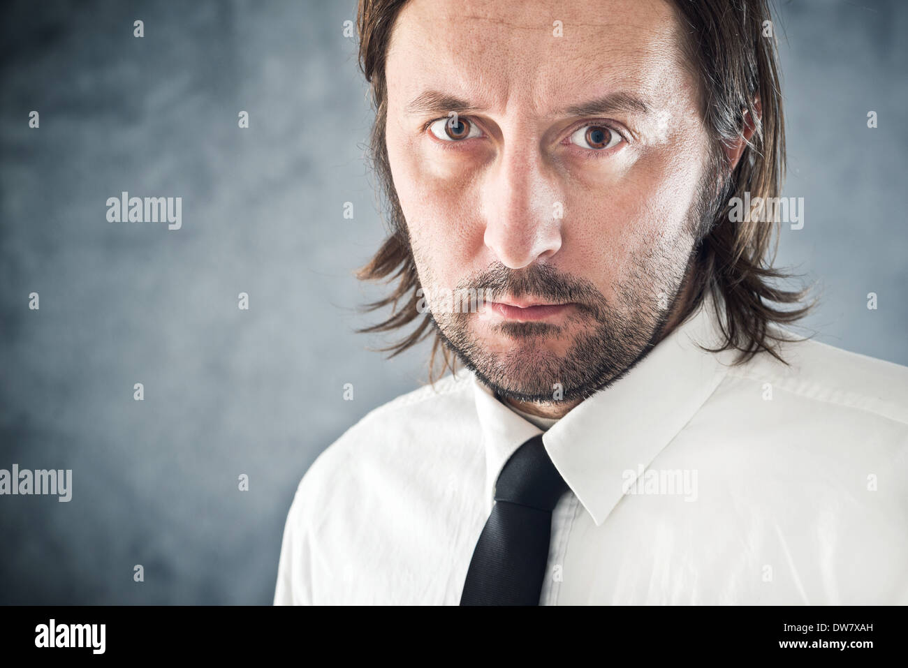 Determined Businessman portrait with copy space. Adult artistic unshaven businessman. Stock Photo