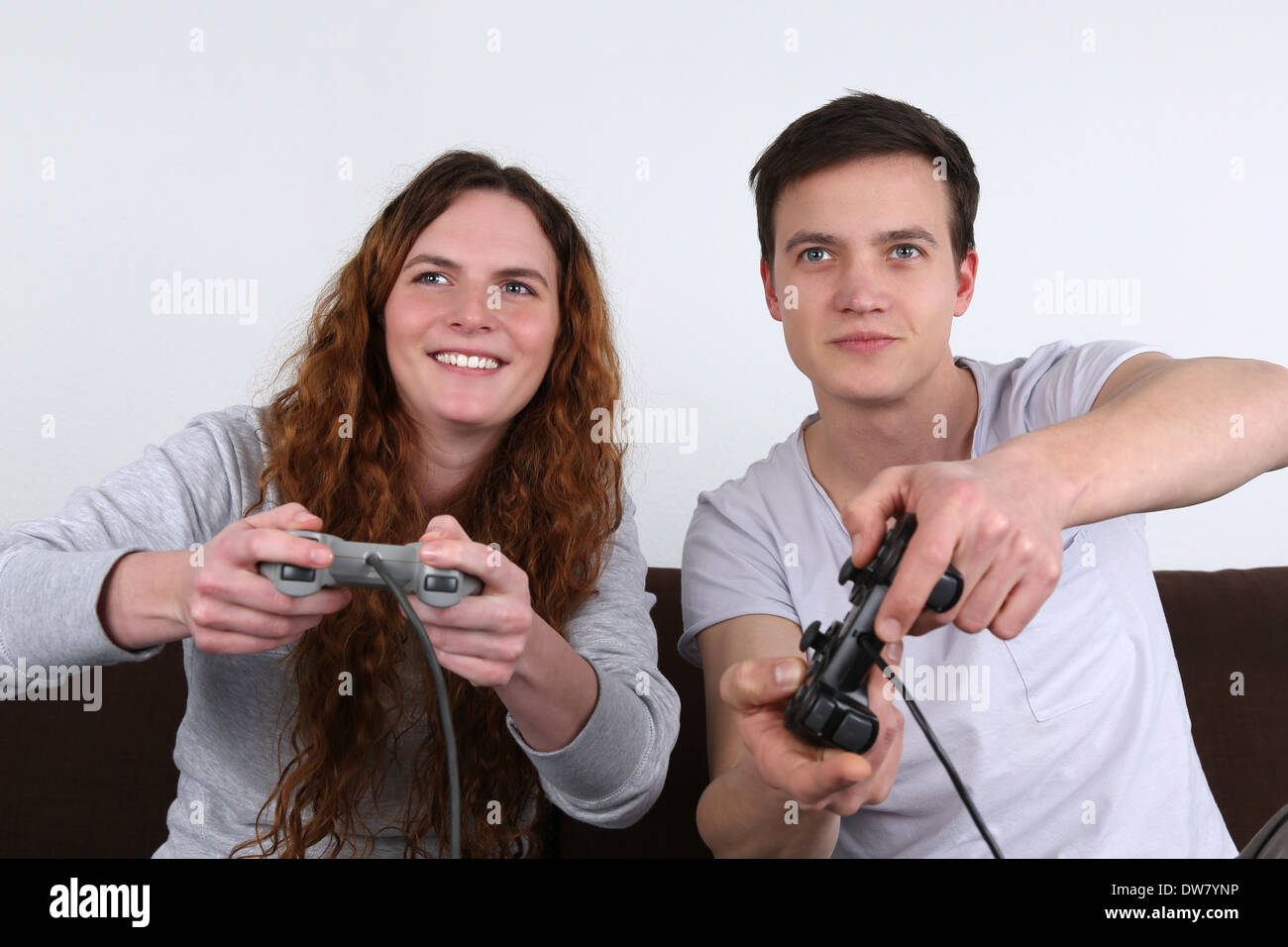 A young couple is playing video games Stock Photo