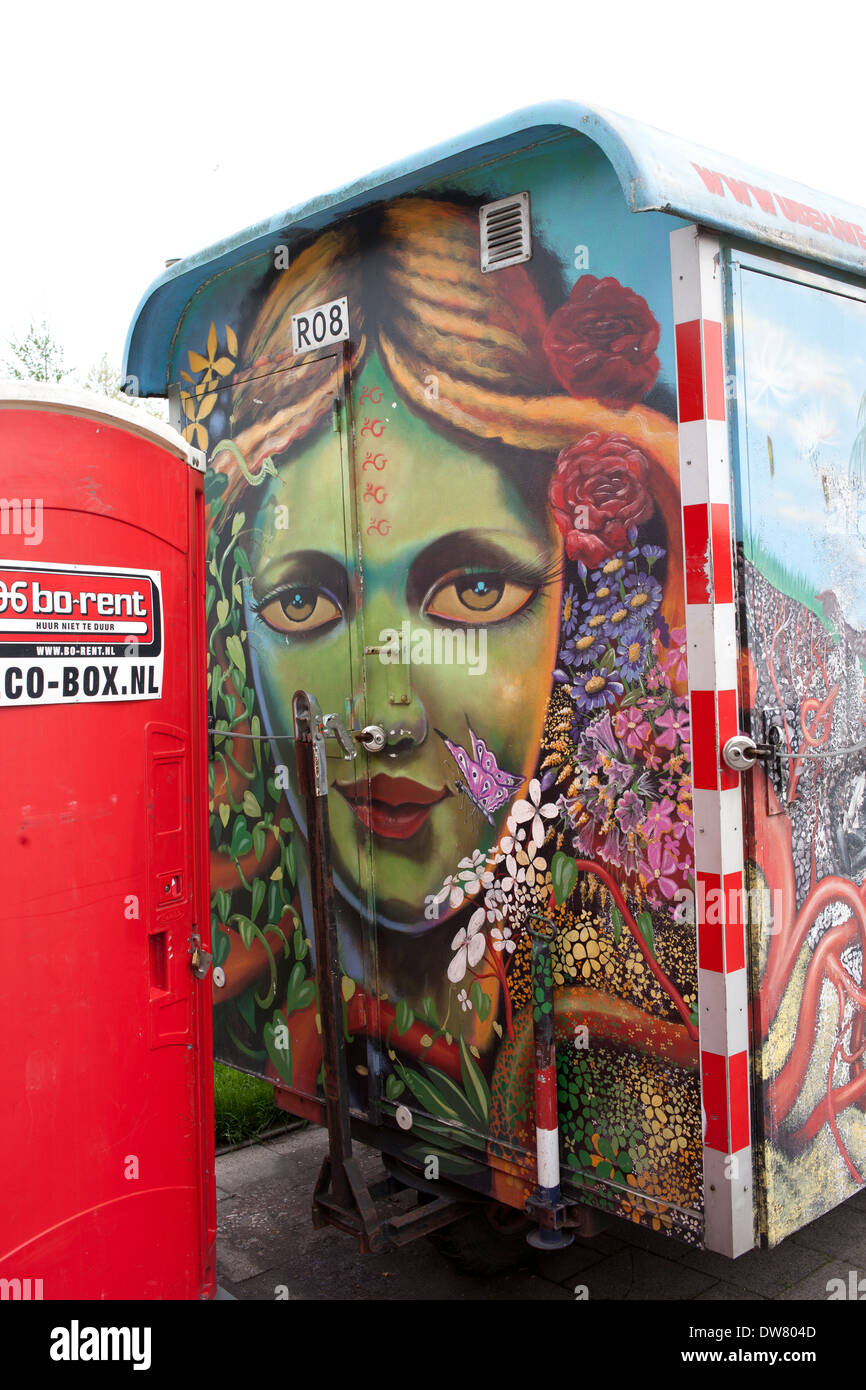 Green skinned blonde woman surrounded with flowers portrait graffiti on a trailer in Rotterdam, Netherlands. Stock Photo