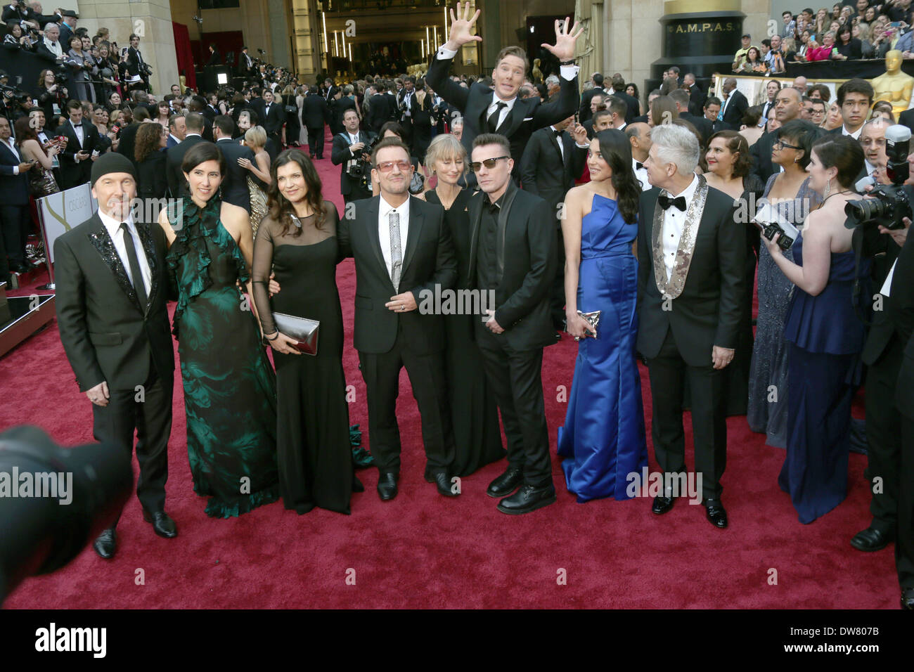 Hollywood, California, USA. 2nd March, 2014. U2 band member The Edge (l-r), Morleigh Steinberg, Ali Hewson, U2 band member Bono, U2 band member Larry Mullen Jr., Mariana Teixeira, and U2 band member Adam Clayton and actor Benedict Cumberbatch jumping behind attend the 86th Academy Awards aka Oscars at Dolby Theatre in Los Angeles, USA, on 02 March 2014.  Credit:   Hubert Boesl/dpa picture alliance/Alamy Live News Stock Photo