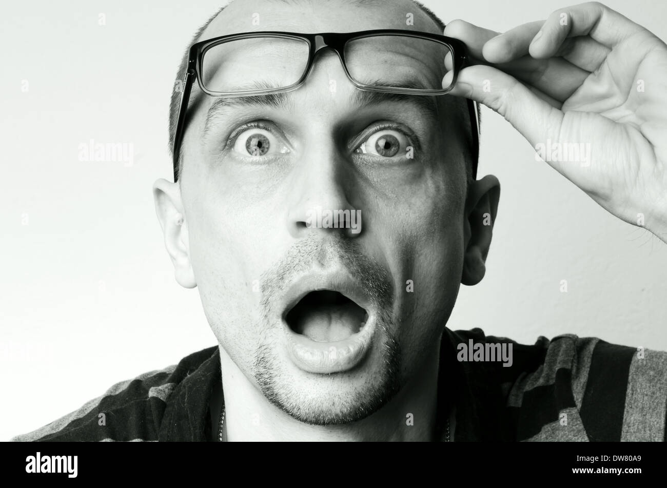 A screaming man raising his glasses Stock Photo