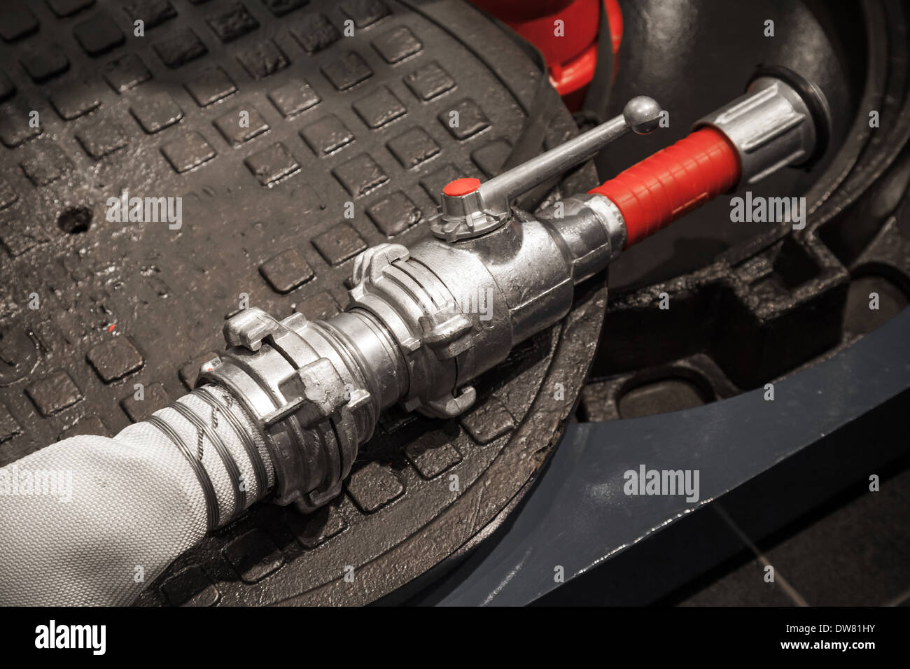 Modern metal firefighters hose on dark background Stock Photo - Alamy