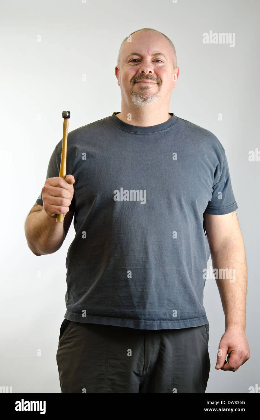 Confident looking man holding a hammer Stock Photo